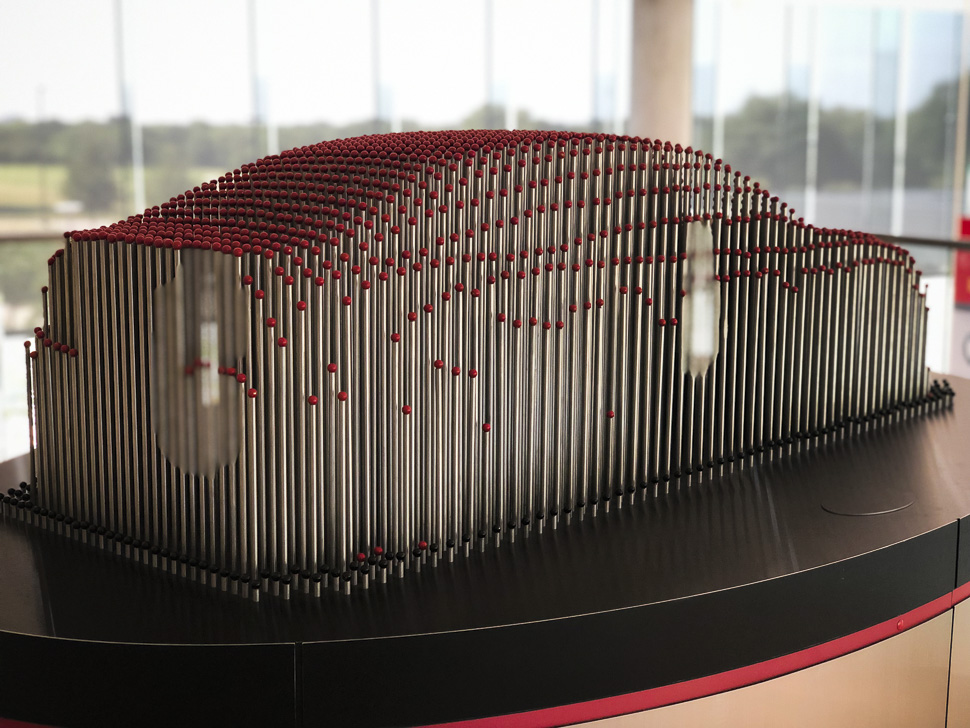 Artwork at the entryway to the Experience Center is an homage to Toyota's origin story: Toyota Industries Corporation was founded in 1926 by Sakichi Toyoda to manufacture and sell the automatic looms which he had invented and perfected.