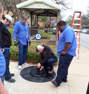 Maintenance workers install of the donated NRG Street Charge stations at UT Arlington. (Photos courtesy the University of Texas at Arlington)