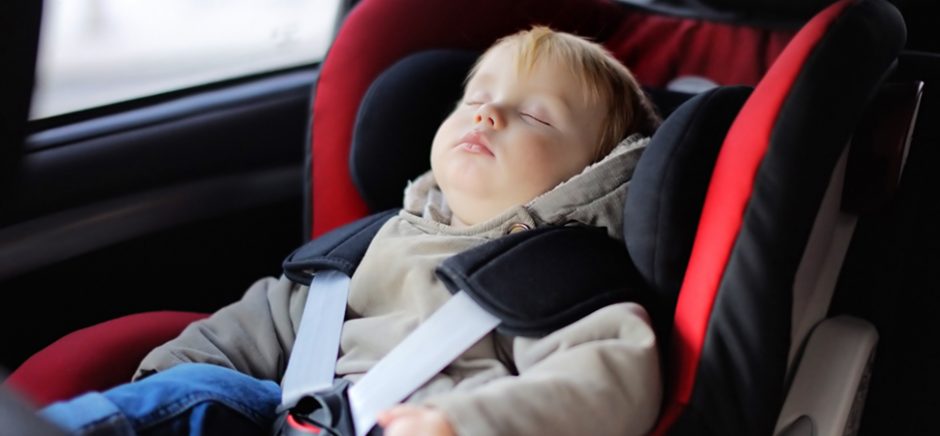 Toddler boy sleeping in car seat