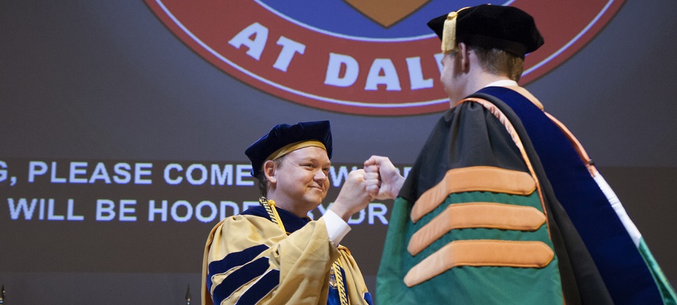 Assistant professor Dr. Walter Voit BS’05, MS’06, fist-bumped Dr. Jonathan Reeder PhD’16, materials science and engineering.