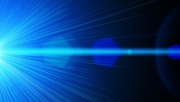 Stock image of A blue bright laser ray on black background
