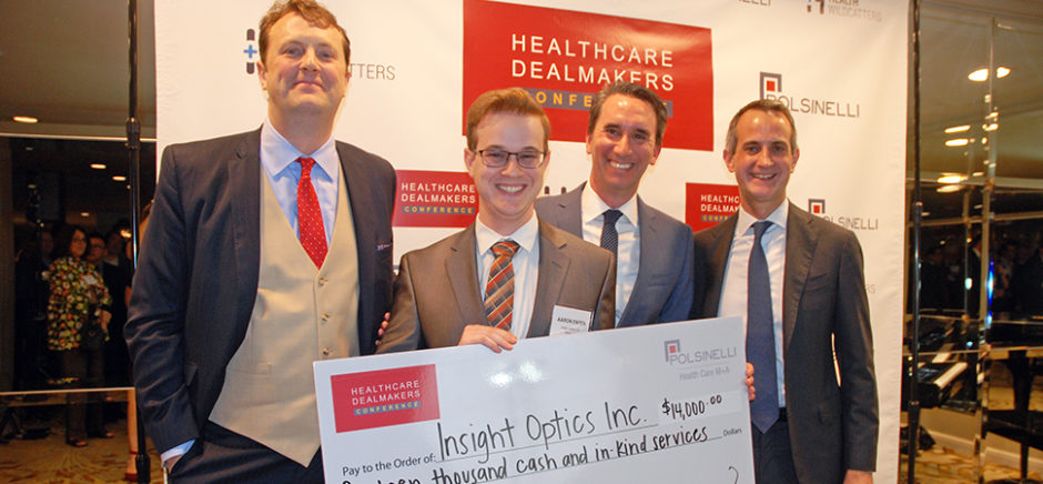 Aaron Enton of Insight Optics holds the winner's check at the Health Wildcatters Pitch
