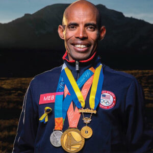 Picture of athlete with several medals around his neck