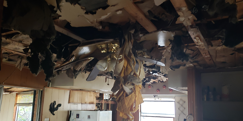 Picture of interior of home with extensive damage from flooding.
