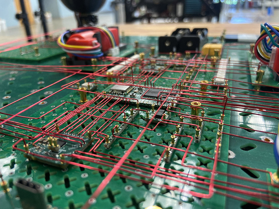 A set of Molecules—Adom’s term for PCBs designed to work with its factory workcells—connected with wires by the company’s robot pincers for prototype testing.