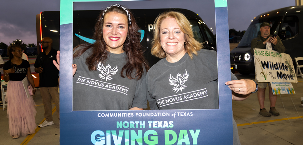 People holding sign for North Texas Giving Day.