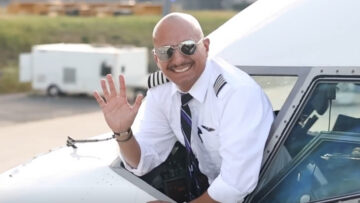 pilot waving from cockpit window