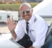 pilot waving from cockpit window