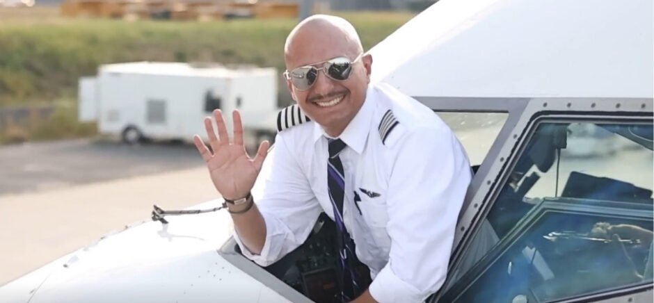 pilot waving from cockpit window